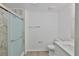 Bathroom featuring a glass shower, marble-look wall tiles, neutral paint, and vinyl flooring at 2112 33Rd Se St, Ruskin, FL 33570