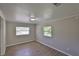 Cozy bedroom with wood-look floors, neutral walls and two windows allowing natural light at 2112 33Rd Se St, Ruskin, FL 33570