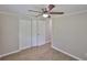 This bedroom features wood-look floors, ceiling fan, and fresh paint at 2112 33Rd Se St, Ruskin, FL 33570