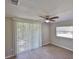 Comfortable bedroom featuring sliding glass doors and a window, providing ample light at 2112 33Rd Se St, Ruskin, FL 33570