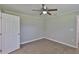 Spacious bedroom showcases hardwood flooring, a white ceiling fan and neutral wall paint at 2112 33Rd Se St, Ruskin, FL 33570
