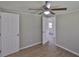 This is a bedroom featuring a ceiling fan, wood-look floors, and fresh gray paint at 2112 33Rd Se St, Ruskin, FL 33570