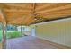 Covered back patio features a ceiling fan and wooden flooring, great for entertaining at 2112 33Rd Se St, Ruskin, FL 33570