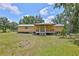 Charming one-story home featuring a covered front porch and well-maintained lawn, inviting outdoor relaxation at 2112 33Rd Se St, Ruskin, FL 33570