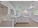 Modern kitchen featuring white cabinets, an island with a sink, and new flooring at 2112 33Rd Se St, Ruskin, FL 33570