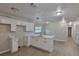 Bright kitchen featuring white cabinetry, center island, recessed lighting, and wood-look flooring at 2112 33Rd Se St, Ruskin, FL 33570