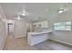 Bright kitchen featuring white cabinetry, center island, recessed lighting, and wood-look flooring at 2112 33Rd Se St, Ruskin, FL 33570