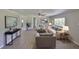Bright living room with hardwood floors, light walls, neutral furniture, and recessed lighting at 2112 33Rd Se St, Ruskin, FL 33570