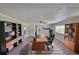 Spacious office featuring hardwood floors, natural light, ceiling fan, and dark wood shelving at 2112 33Rd Se St, Ruskin, FL 33570