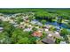 Scenic aerial shot showcases the community's proximity to a tranquil lake and lush green landscape at 2498 Saddlewood Ln, Palm Harbor, FL 34685
