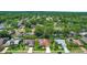 Expansive aerial view of homes in a community with lush greenery and well-maintained lawns at 2498 Saddlewood Ln, Palm Harbor, FL 34685