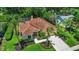 Aerial view of a home with well-kept lawn and mature trees at 2498 Saddlewood Ln, Palm Harbor, FL 34685