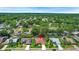 Real estate pin on an aerial view of homes in a community with lush greenery and well-maintained lawns at 2498 Saddlewood Ln, Palm Harbor, FL 34685
