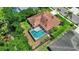 Overhead view of a home with screened pool and mature trees at 2498 Saddlewood Ln, Palm Harbor, FL 34685