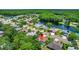 Real estate pin on an aerial view showcasing the community's proximity to a tranquil lake and lush green landscape at 2498 Saddlewood Ln, Palm Harbor, FL 34685
