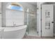 Bright bathroom featuring large shower, soaking tub, and modern fixtures at 2498 Saddlewood Ln, Palm Harbor, FL 34685