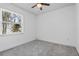 A simple, carpeted bedroom with a window and ample natural light at 2498 Saddlewood Ln, Palm Harbor, FL 34685