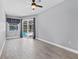 Spacious bedroom features a ceiling fan, access to the backyard pool, and natural light at 2498 Saddlewood Ln, Palm Harbor, FL 34685