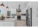 Modern kitchen with white cabinets, stainless steel appliances, and stylish backsplash at 2498 Saddlewood Ln, Palm Harbor, FL 34685