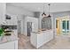 Well-lit kitchen with stainless steel appliances, island and view of the backyard pool at 2498 Saddlewood Ln, Palm Harbor, FL 34685