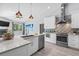 Updated kitchen featuring stainless steel appliances, white cabinets and an island sink at 2498 Saddlewood Ln, Palm Harbor, FL 34685