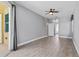 Large living room with light grey walls and wood-look flooring at 2498 Saddlewood Ln, Palm Harbor, FL 34685