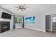 A bright, spacious living room features a fireplace and a ceiling fan at 2498 Saddlewood Ln, Palm Harbor, FL 34685