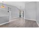 Spacious living room featuring wood-look tile flooring with open floor plan at 2498 Saddlewood Ln, Palm Harbor, FL 34685