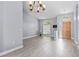 Inviting living room showcasing wood-look tile flooring and modern light fixture at 2498 Saddlewood Ln, Palm Harbor, FL 34685