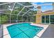 Inviting in-ground pool with screened-in enclosure, and patio at 2498 Saddlewood Ln, Palm Harbor, FL 34685
