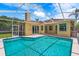 In-ground swimming pool with screened enclosure offers relaxation at 2498 Saddlewood Ln, Palm Harbor, FL 34685