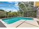 Sparkling in-ground pool with screened-in enclosure, perfect for outdoor enjoyment at 2498 Saddlewood Ln, Palm Harbor, FL 34685