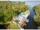 Aerial view of a home with pool, dock, boat, and waterfront access on canal at 2533 Dolly Bay Dr # 203, Palm Harbor, FL 34684