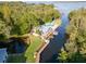 Aerial view of waterfront property with a pool, dock, and lush greenery at 2533 Dolly Bay Dr # 203, Palm Harbor, FL 34684