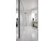 Well-lit bathroom with full mirrors, closet and bright white tile flooring at 2533 Dolly Bay Dr # 203, Palm Harbor, FL 34684