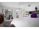 Bright bedroom with a large bed, ceiling fan, and access to a screened-in porch at 2533 Dolly Bay Dr # 203, Palm Harbor, FL 34684