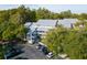 Overhead view of condo with balconies surrounded by trees, showcasing parking and landscaping at 2533 Dolly Bay Dr # 203, Palm Harbor, FL 34684