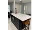 Kitchen island with counter seating, perfect for meal prep, stainless microwave, and entertaining guests at 2533 Dolly Bay Dr # 203, Palm Harbor, FL 34684