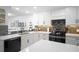 Modern kitchen with white cabinets, quartz countertops, stylish backsplash, and stainless steel appliances at 2533 Dolly Bay Dr # 203, Palm Harbor, FL 34684