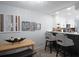 Open-concept eat-in kitchen with white cabinets and quartz countertops that flow into a cozy living room area at 2533 Dolly Bay Dr # 203, Palm Harbor, FL 34684
