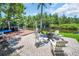 Outdoor patio area with brick pavers, patio furniture, fire pit, and tranquil water views perfect for entertaining at 2533 Dolly Bay Dr # 203, Palm Harbor, FL 34684