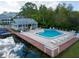 A beautiful in-ground pool is surrounded by lounge chairs and a nearby recreation building with a metal roof at 2533 Dolly Bay Dr # 203, Palm Harbor, FL 34684