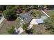 An aerial view shows this home's pool, detached garage, circular driveway and mature landscaping at 27709 Robin Roost Ln, Wesley Chapel, FL 33544