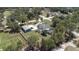 A lovely aerial view of this home, featuring a screened pool, spacious yard, and detached garage at 27709 Robin Roost Ln, Wesley Chapel, FL 33544