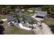 Beautiful home featuring mature landscaping, a screened in lanai, attached garage and separate carport with a long driveway at 27709 Robin Roost Ln, Wesley Chapel, FL 33544