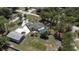Aerial view of a gray roof house with a detached garage and swimming pool in the yard at 27709 Robin Roost Ln, Wesley Chapel, FL 33544