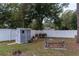 A gray shed and white fencing define the backyard's boundary at 27709 Robin Roost Ln, Wesley Chapel, FL 33544