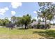Spacious backyard with well-maintained lawn, mature trees, shed, and serene outdoor setting at 27709 Robin Roost Ln, Wesley Chapel, FL 33544