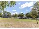 Expansive backyard featuring a shed, white fencing, lush greenery, and serene atmosphere at 27709 Robin Roost Ln, Wesley Chapel, FL 33544