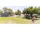 Expansive backyard showcasing lush greenery, a shed, white fencing and outdoor amenities at 27709 Robin Roost Ln, Wesley Chapel, FL 33544